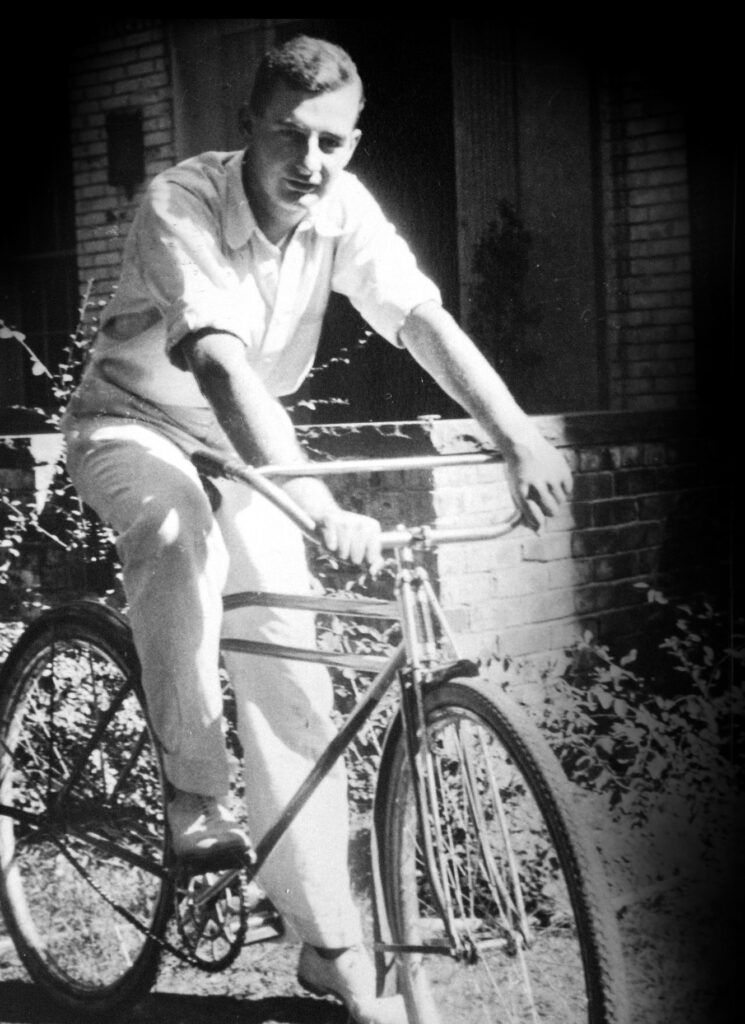 Black and white photograph of Raoul Wallenberg on a bicycle.